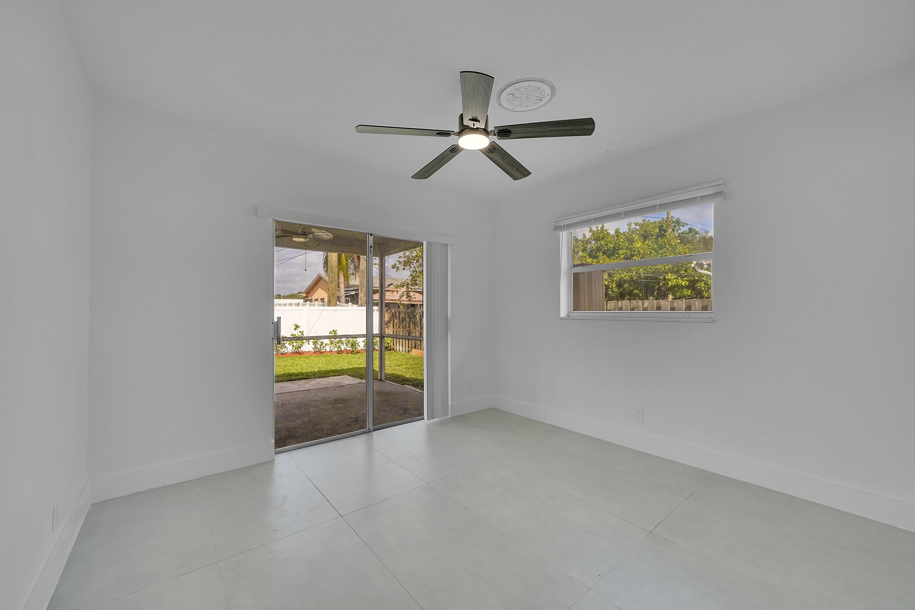 2821 Northeast 2nd Avenue, Unit 2823 Boca Raton, FL 33431 - Photo 11 of 38 an empty room with windows and ceiling fan view