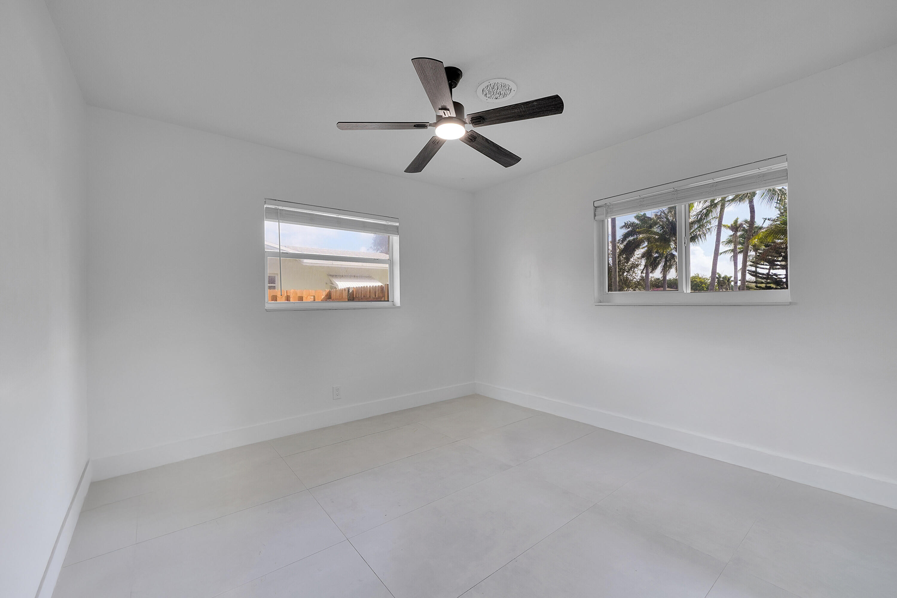 2821 Northeast 2nd Avenue, Unit 2823 Boca Raton, FL 33431 - Photo 13 of 38 an empty room with window and a ceiling fan