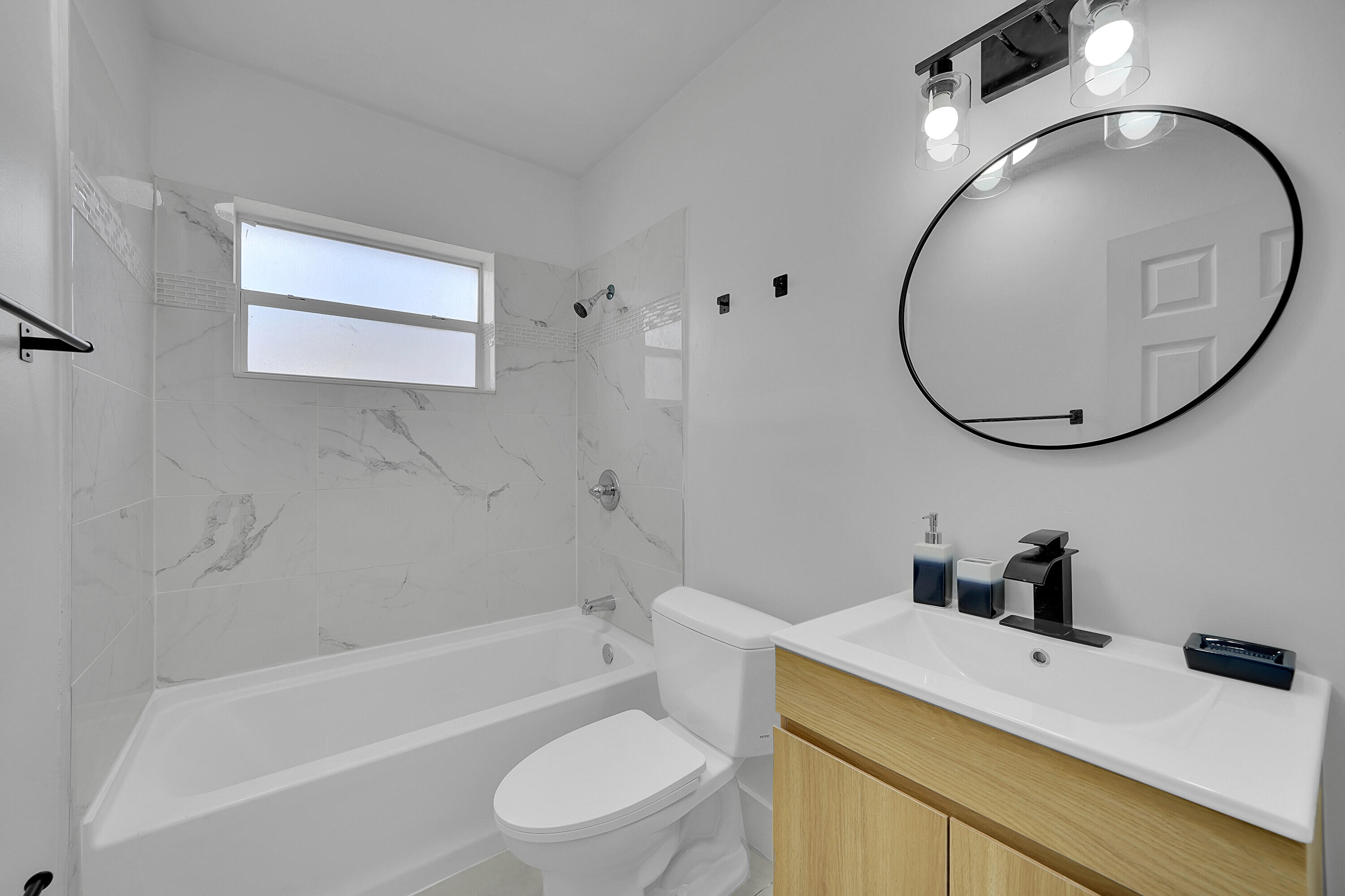 2821 Northeast 2nd Avenue, Unit 2823 Boca Raton, FL 33431 - Photo 14 of 38 a bathroom with a sink a toilet and a mirror