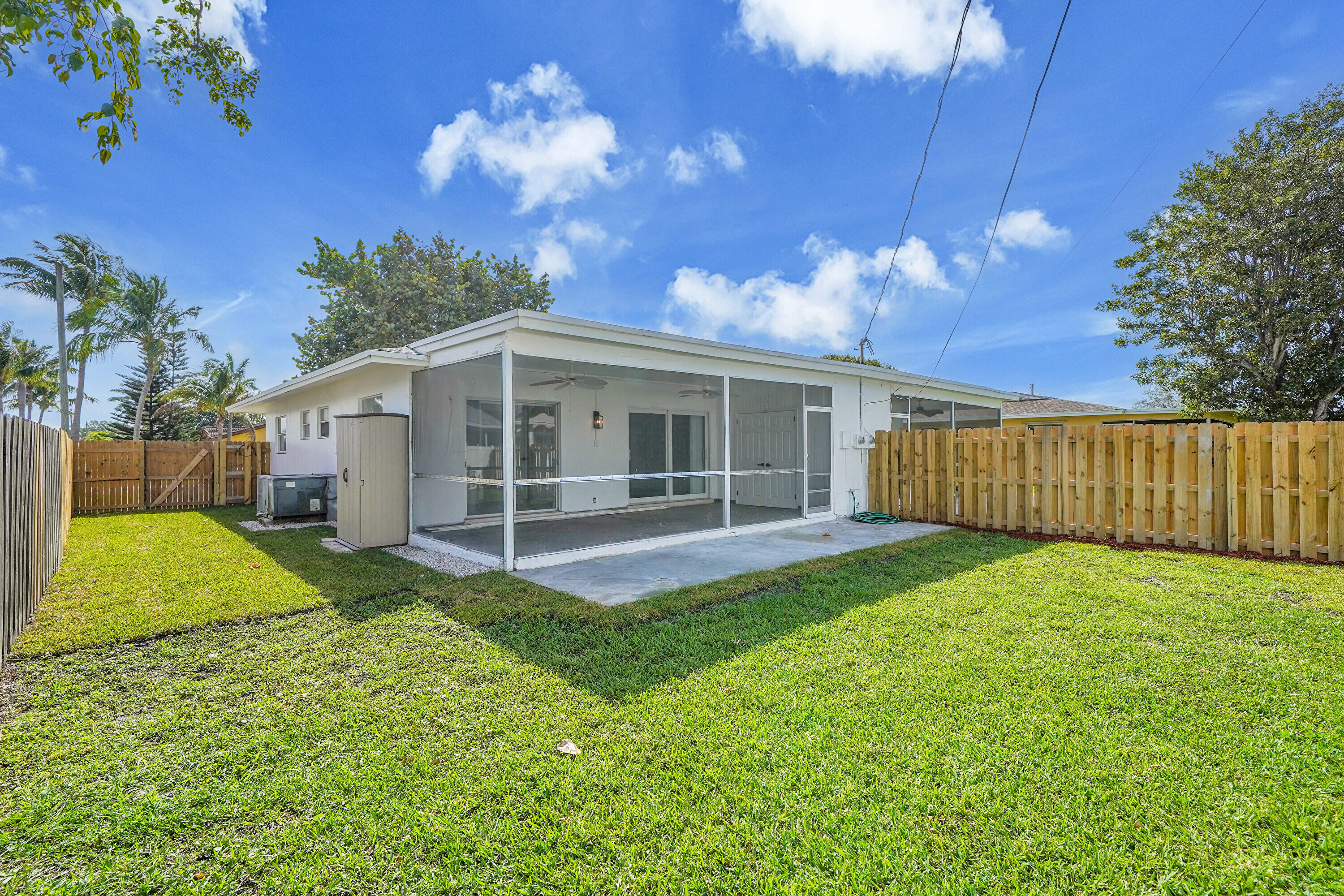 2821 Northeast 2nd Avenue, Unit 2823 Boca Raton, FL 33431 - Photo 18 of 38 a view of a house with backyard and a tree