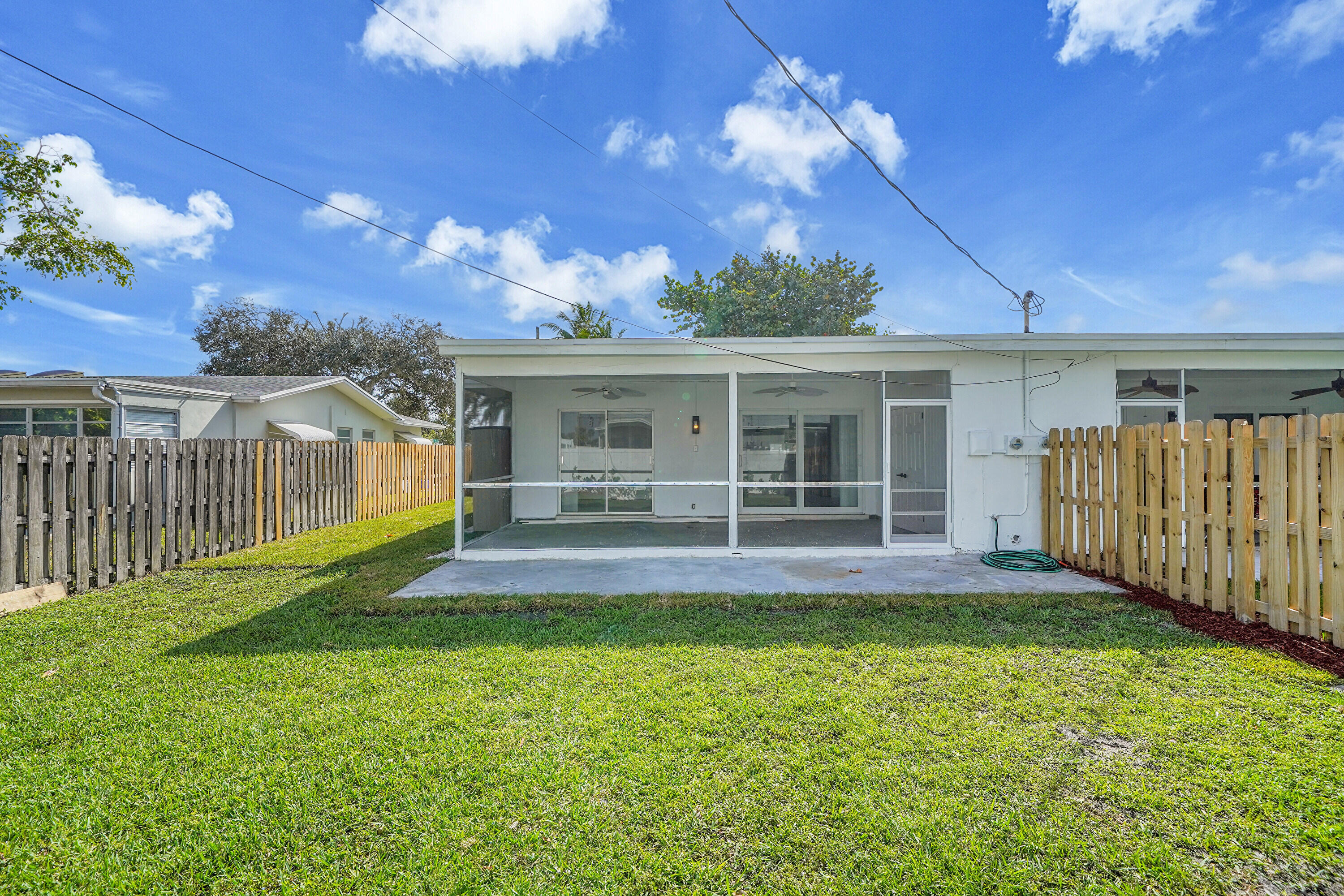 2821 Northeast 2nd Avenue, Unit 2823 Boca Raton, FL 33431 - Photo 19 of 38 a view of a house with a yard and porch
