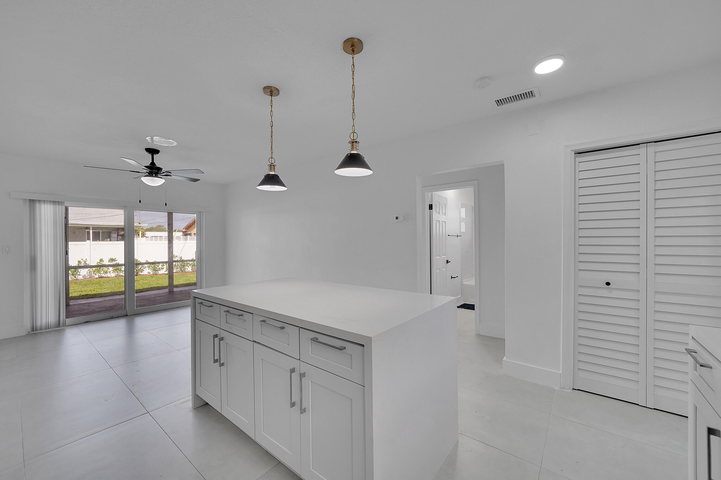 2821 Northeast 2nd Avenue, Unit 2823 Boca Raton, FL 33431 - Photo 4 of 38 a kitchen with white cabinets and window
