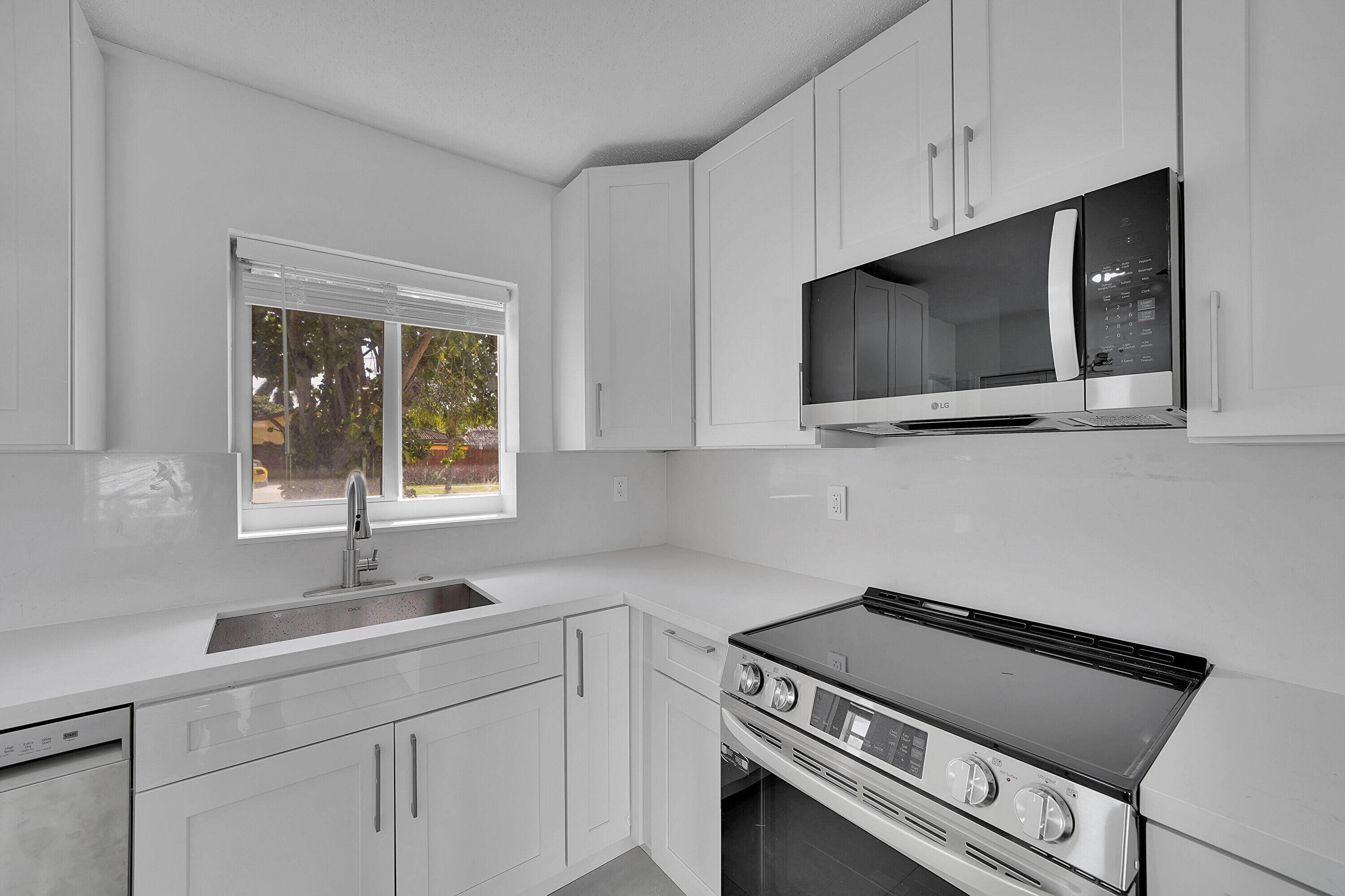 2821 Northeast 2nd Avenue, Unit 2823 Boca Raton, FL 33431 - Photo 7 of 38 a kitchen with a sink and cabinets