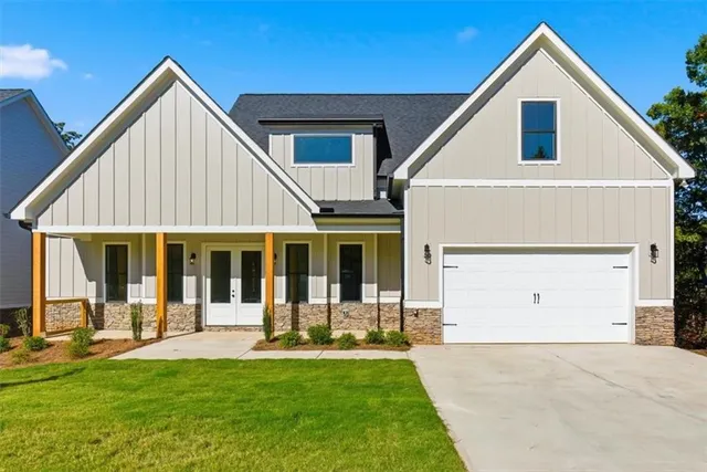 a view of a house with a yard and porch