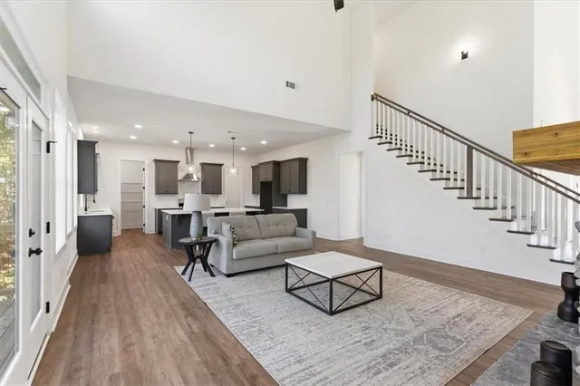 a living room with furniture and wooden floor