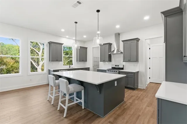 a kitchen with a table chairs sink and refrigerator