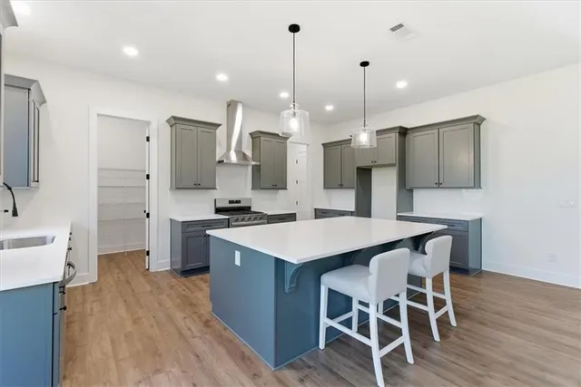 a kitchen with a table chairs refrigerator a sink and a stove