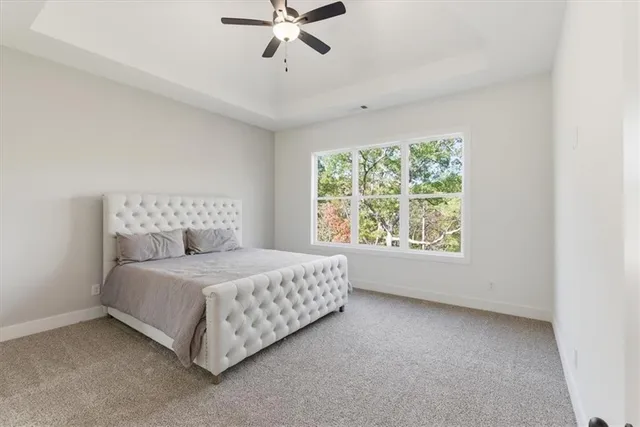 a spacious bedroom with a bed and window