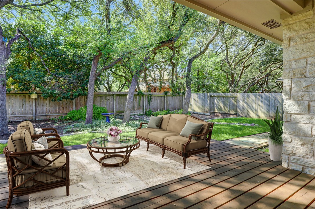 a view of backyard with outdoor seating and trees