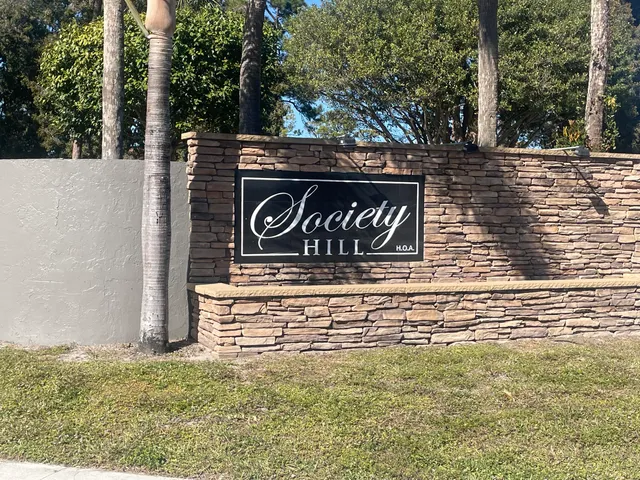 a view of a street sign under a tree