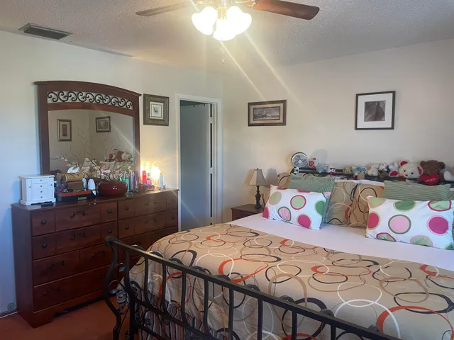 a bedroom with a bed and a dresser