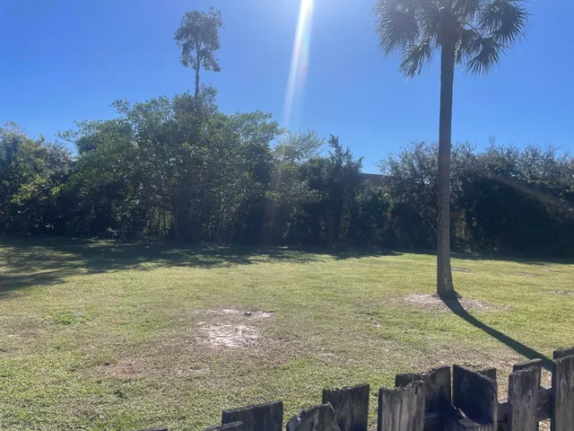 a view of a pool with a house