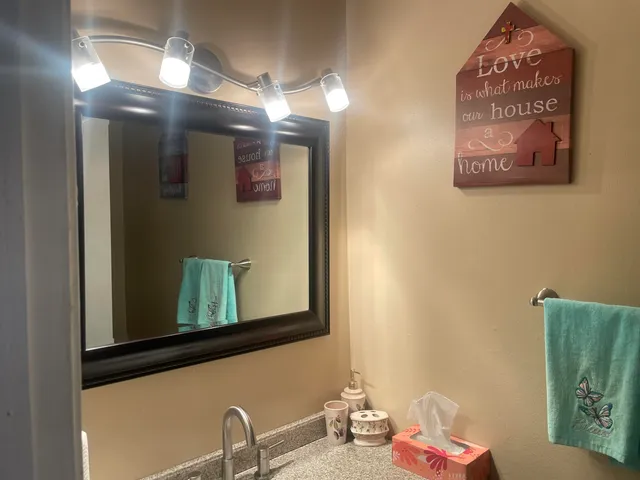 a bathroom with a mirror and a sink