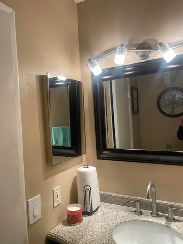a bathroom with a sink and a mirror