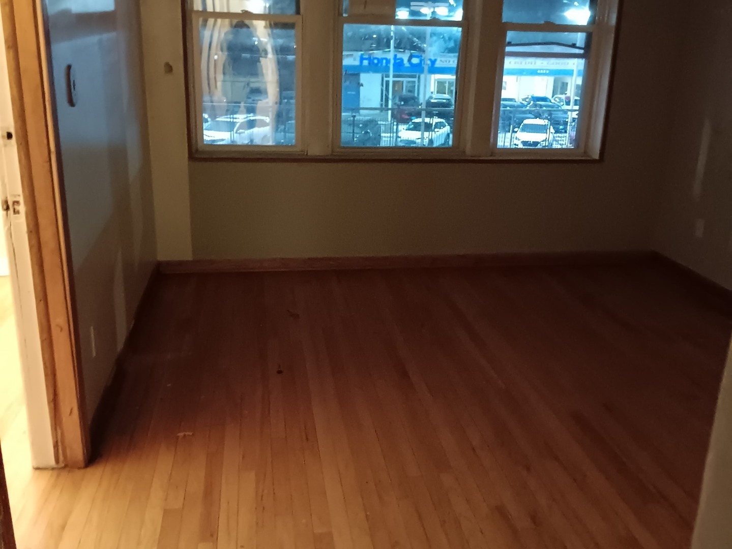 4846 South Pulaski Road, Unit 2 Chicago, IL 60632 - Photo 3 of 9 a view of an empty room with wooden floor and a window