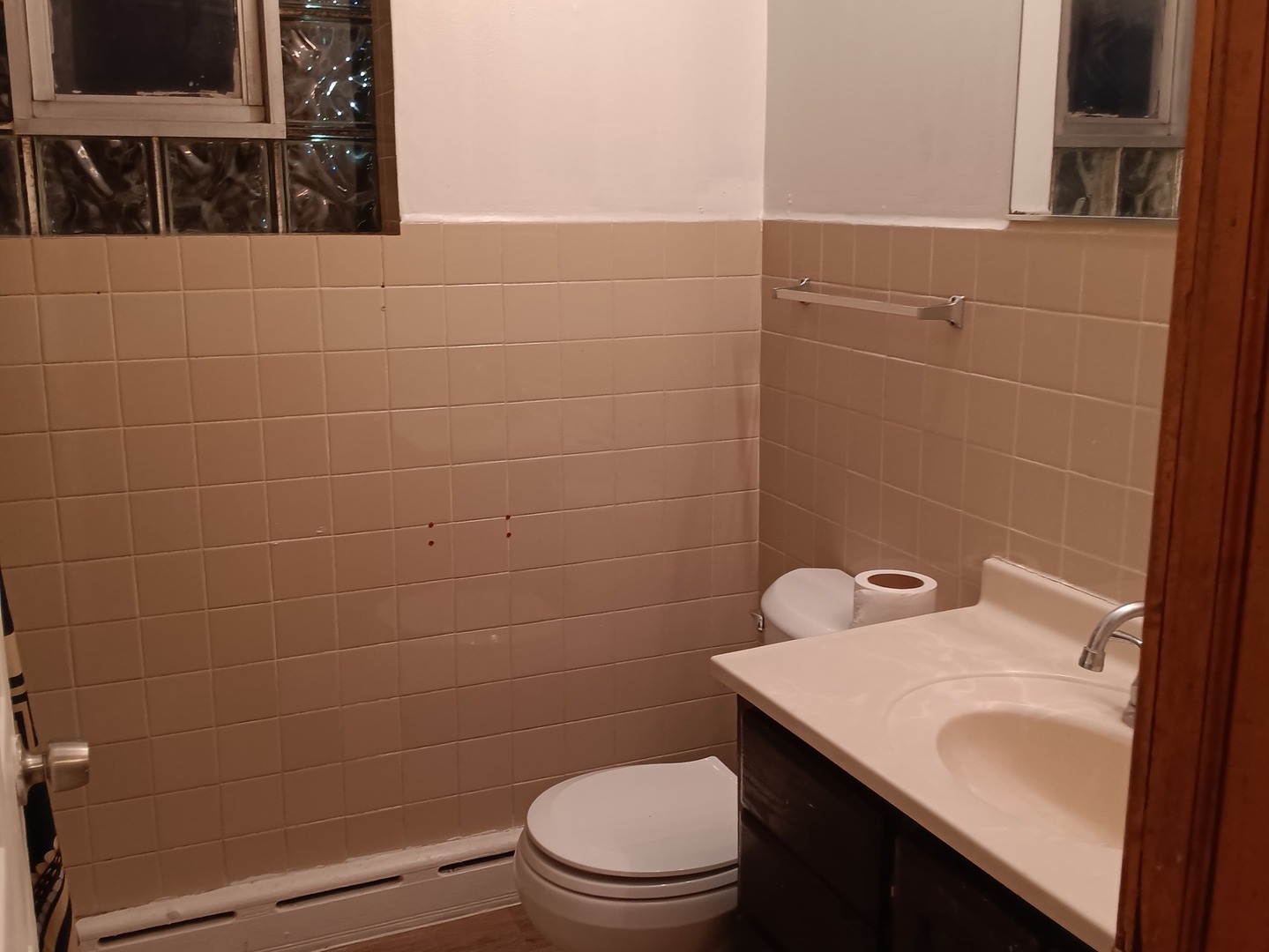 4846 South Pulaski Road, Unit 2 Chicago, IL 60632 - Photo 5 of 9 a bathroom with a sink a toilet and a mirror