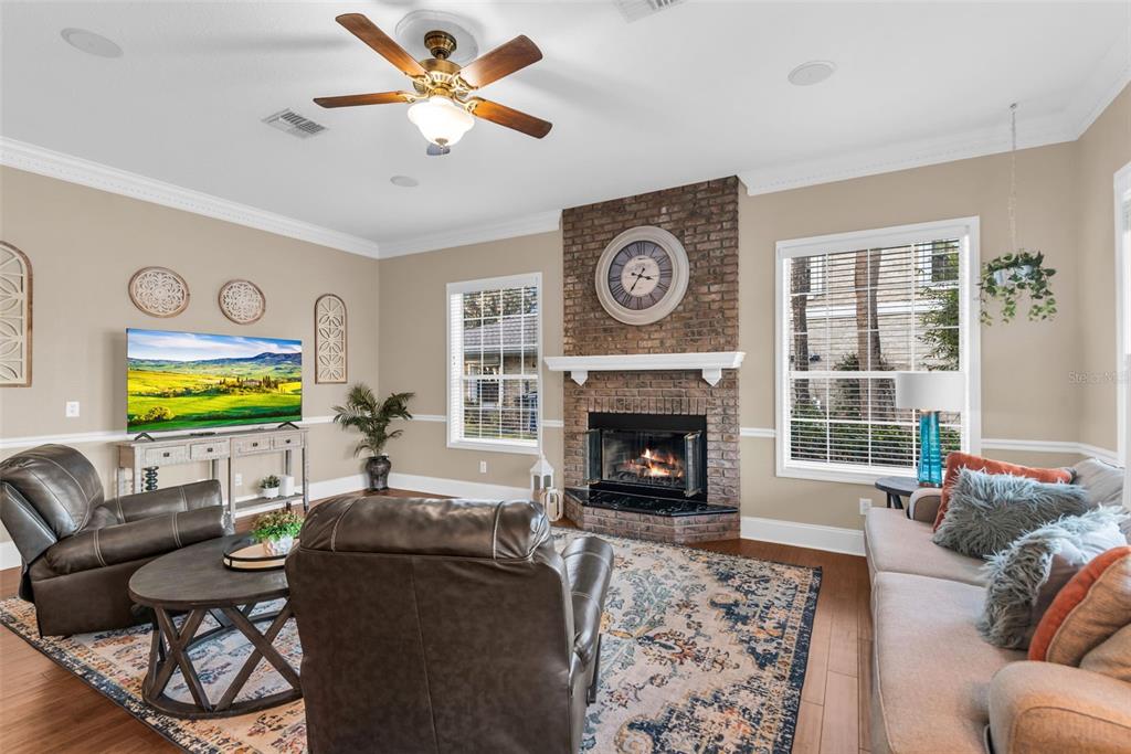 1425 Riviera Drive Kissimmee, FL 34744 - Photo 11 of 82 a living room with furniture a fireplace and a flat screen tv