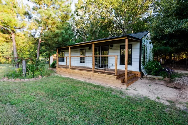 a backyard of a house with table and chairs