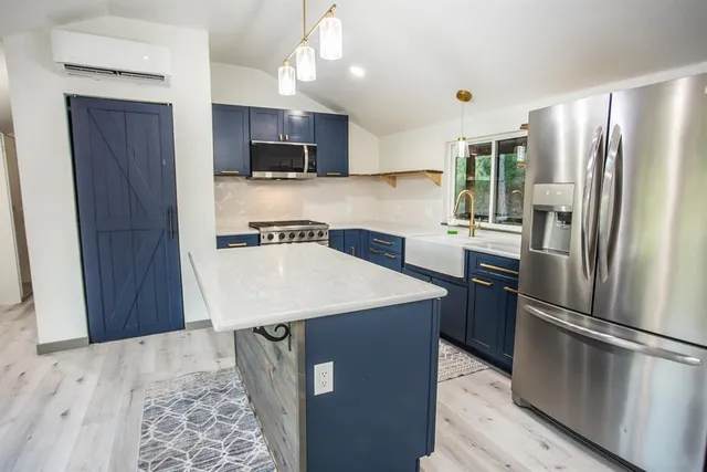 a kitchen with stainless steel appliances a refrigerator stove microwave and sink