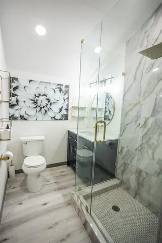 a bathroom with a toilet sink and shower