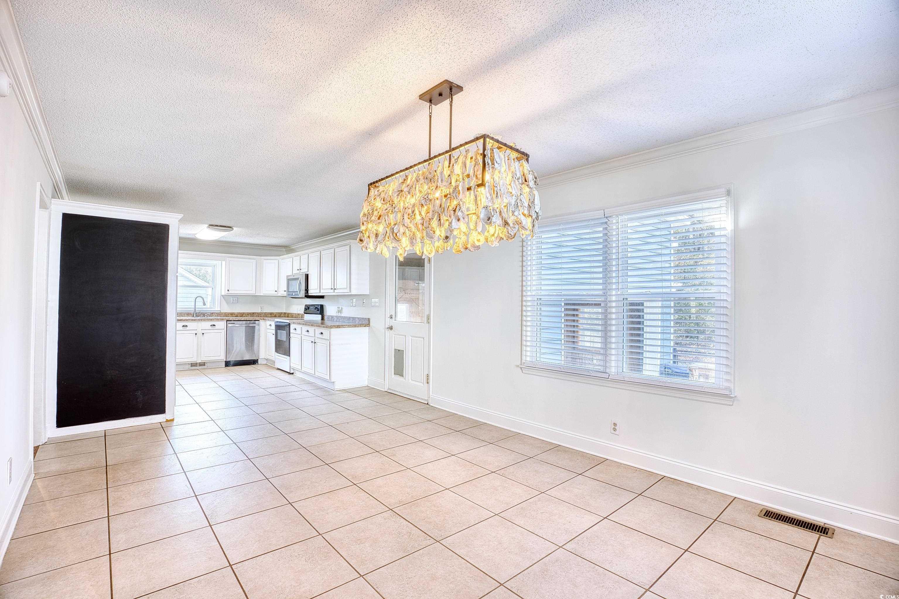 116 Great Lakes Road Pawleys Island, SC 29585 - Photo 13 of 37 Kitchen with pendant lighting, sink, light tile pa