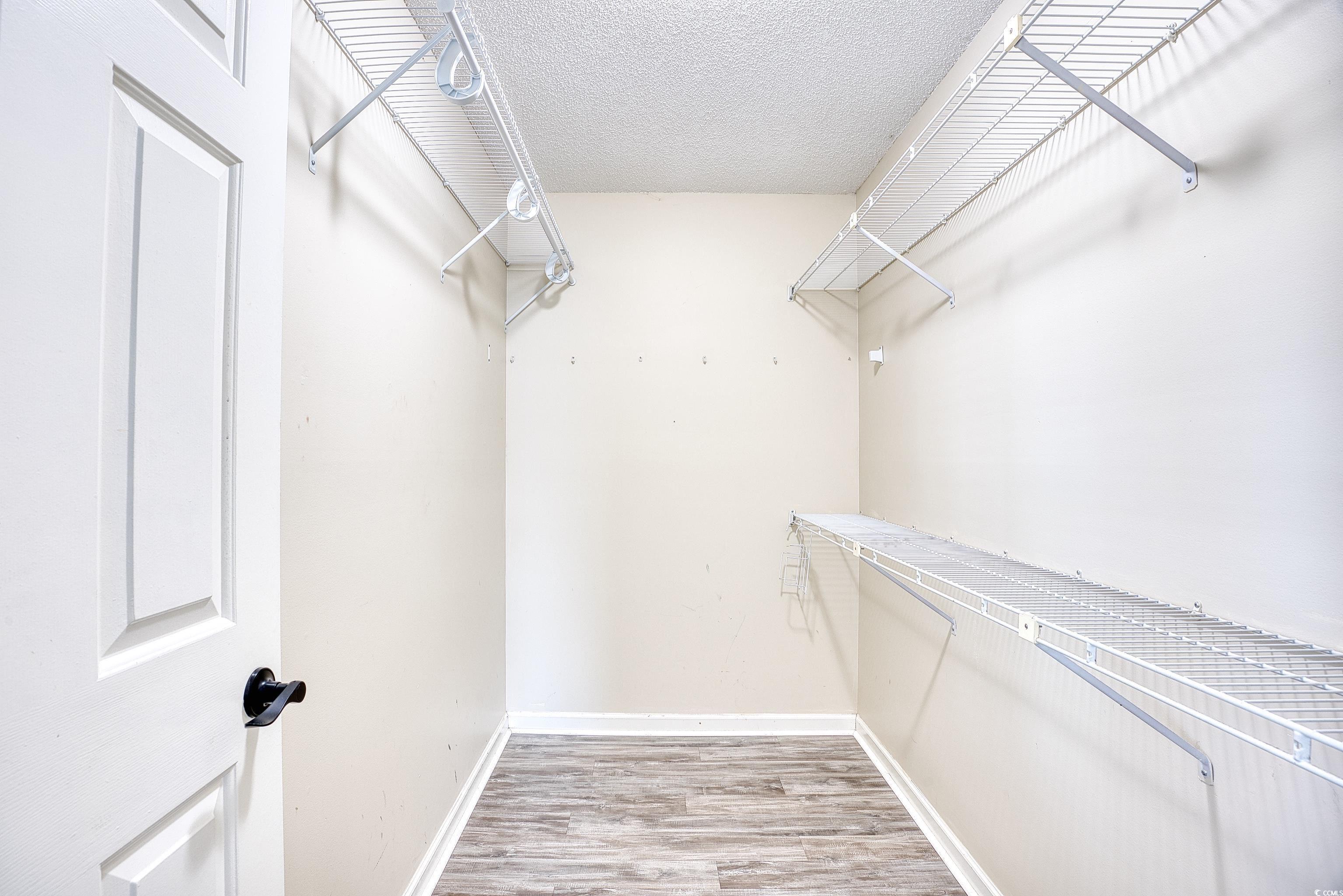 116 Great Lakes Road Pawleys Island, SC 29585 - Photo 24 of 37 Walk in closet featuring hardwood / wood-style flo