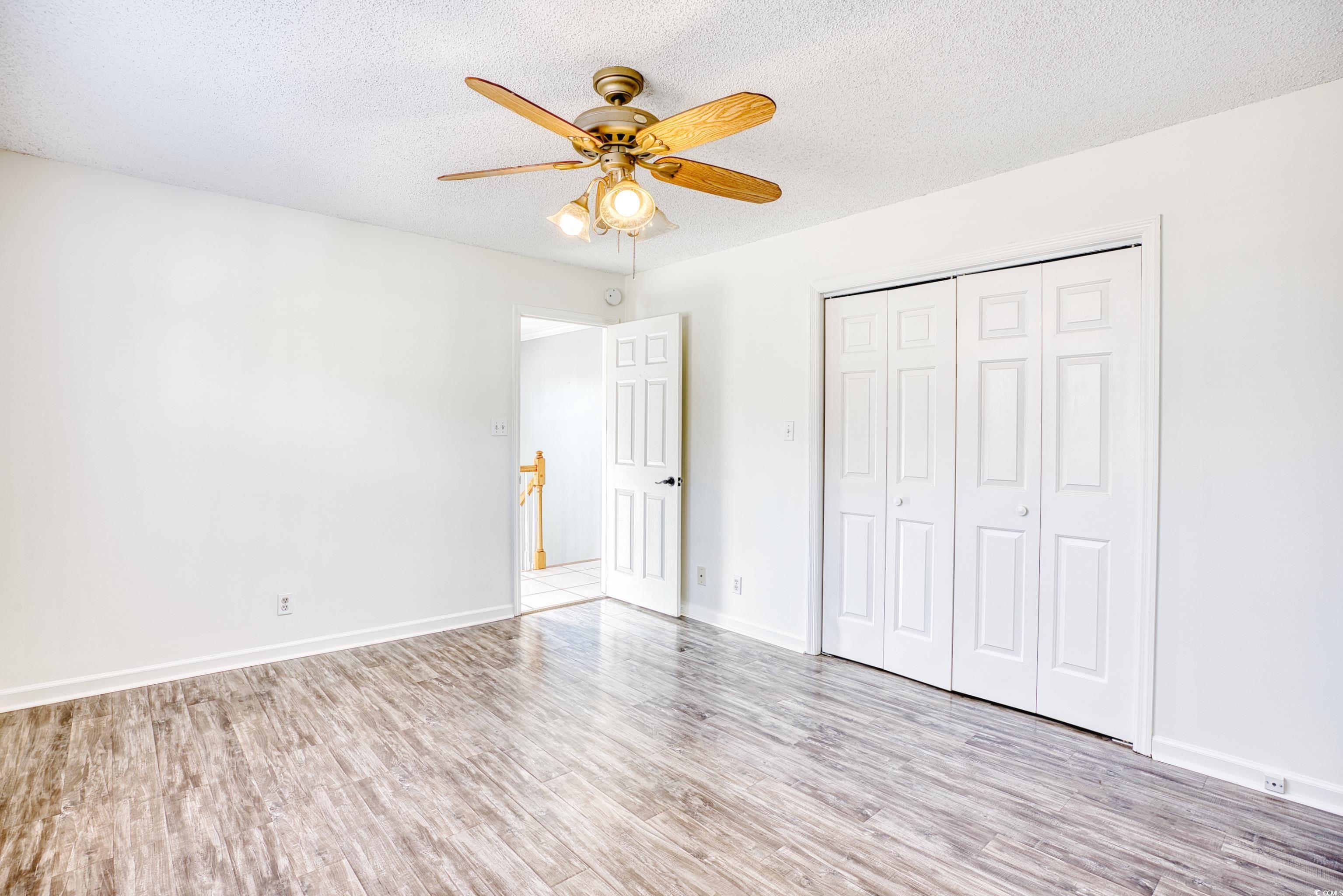 116 Great Lakes Road Pawleys Island, SC 29585 - Photo 25 of 37 Unfurnished bedroom featuring ceiling fan, a textu