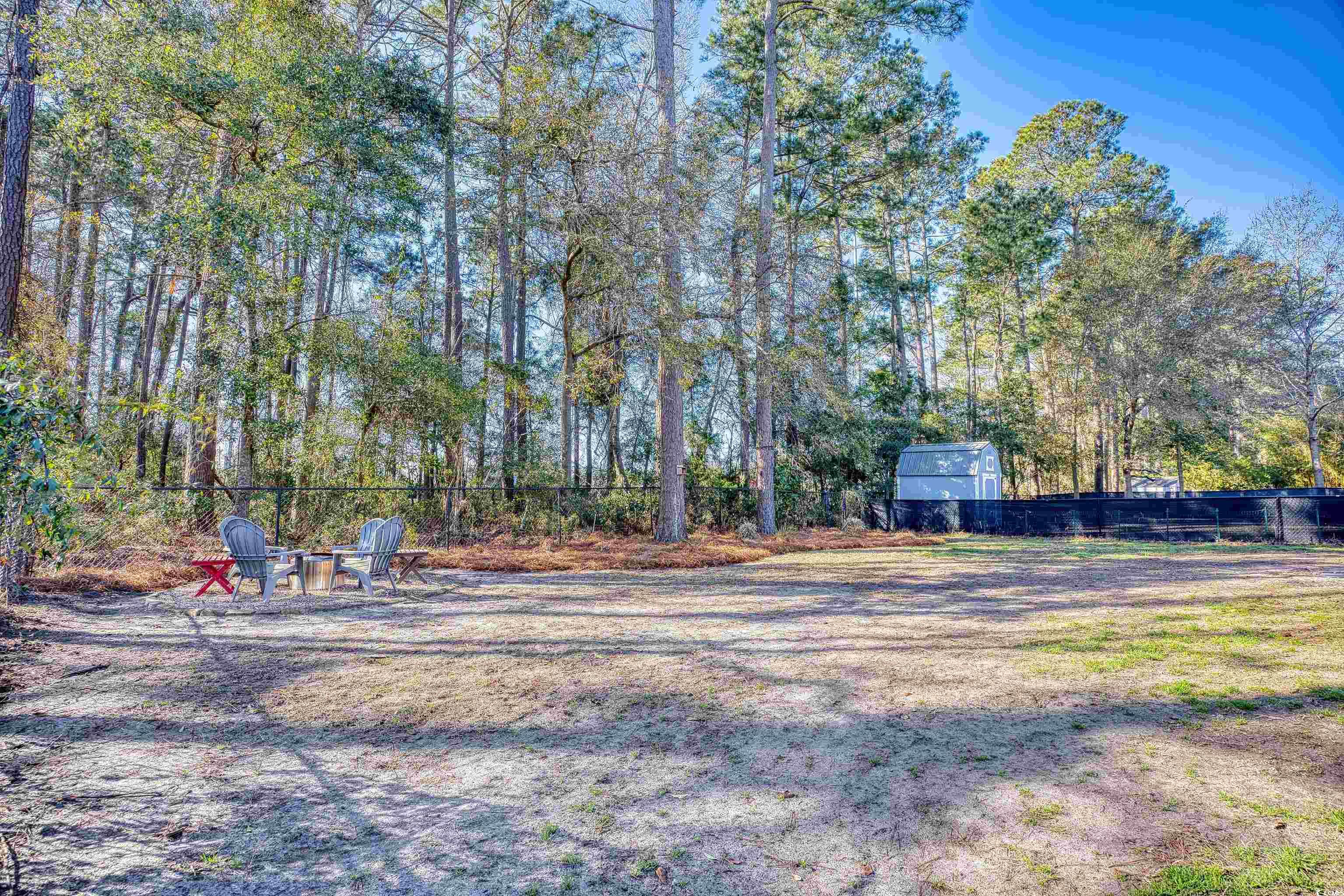 116 Great Lakes Road Pawleys Island, SC 29585 - Photo 30 of 37 View of yard featuring an outdoor fire pit
