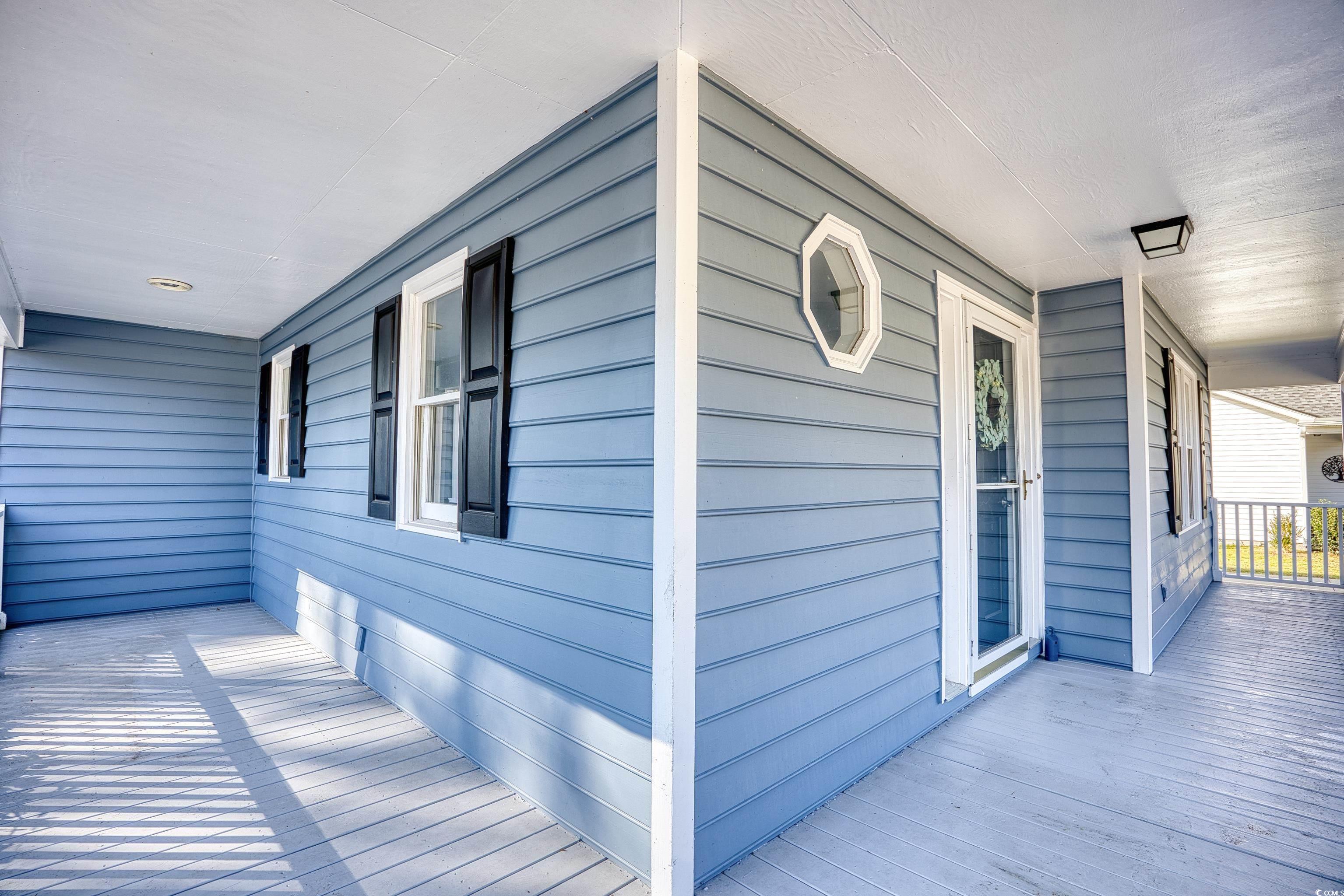 116 Great Lakes Road Pawleys Island, SC 29585 - Photo 4 of 37 View of side of home featuring a porch