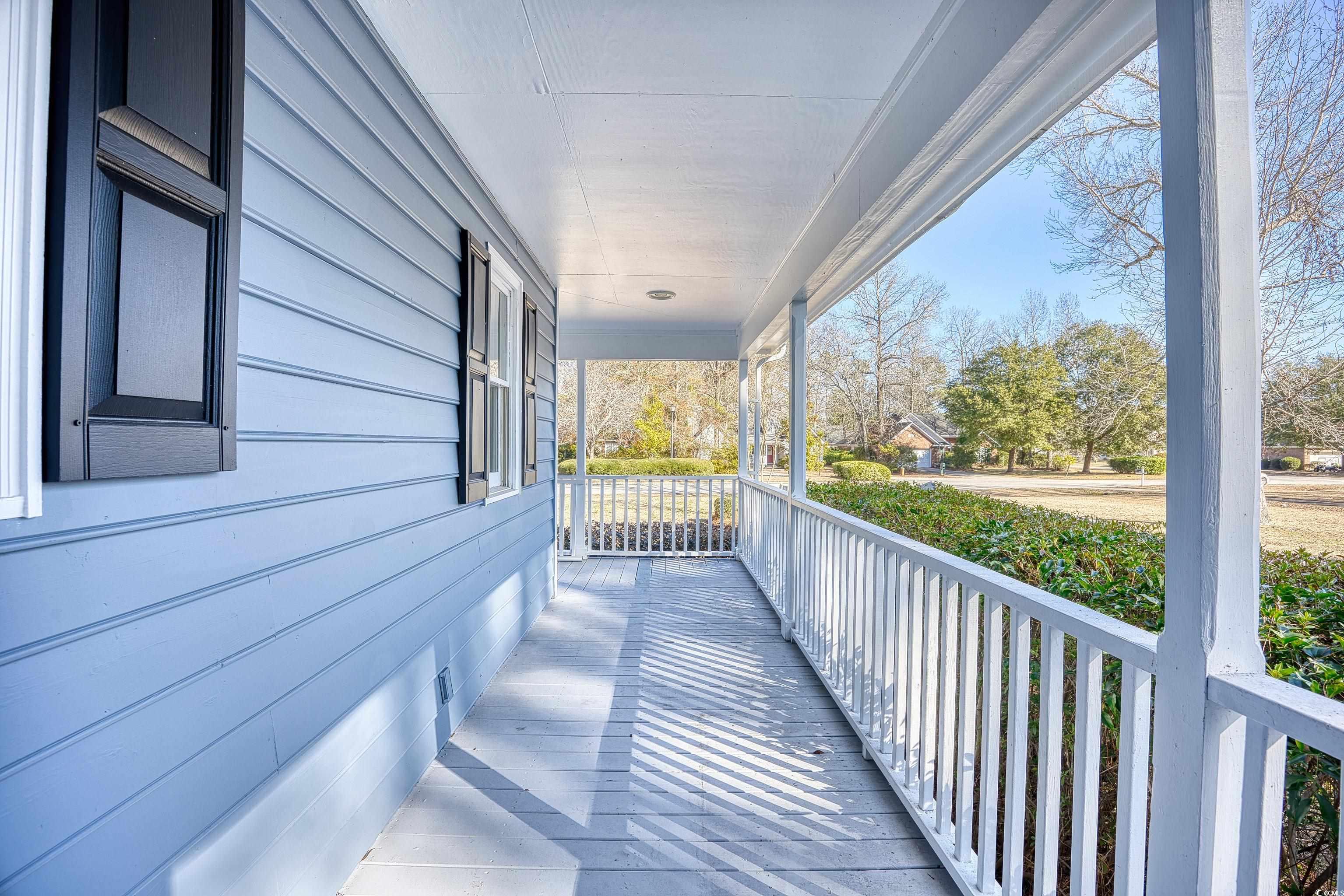 116 Great Lakes Road Pawleys Island, SC 29585 - Photo 5 of 37 Wooden deck featuring covered porch