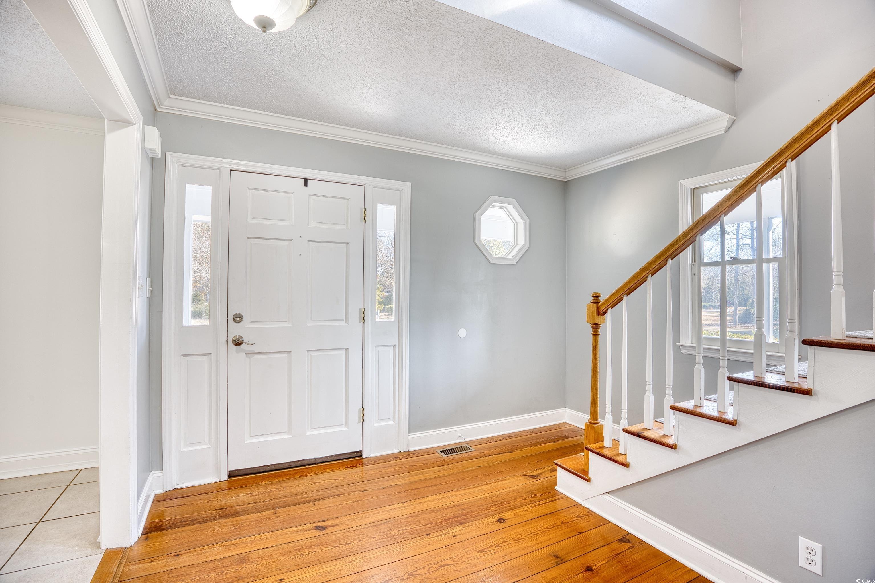 116 Great Lakes Road Pawleys Island, SC 29585 - Photo 7 of 37 Foyer with crown molding, a textured ceiling, and