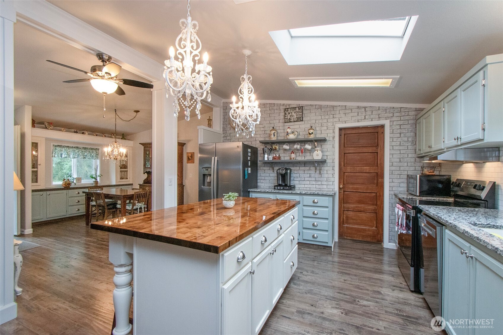 141 Lavender Ridge Lane Sequim, WA 98382 - Photo 14 of 40 a kitchen with stainless steel appliances granite countertop a sink refrigerator and cabinets