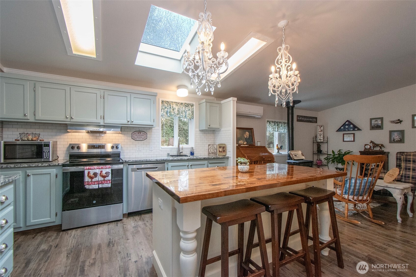 141 Lavender Ridge Lane Sequim, WA 98382 - Photo 16 of 40 a kitchen with a table chairs stove and cabinets