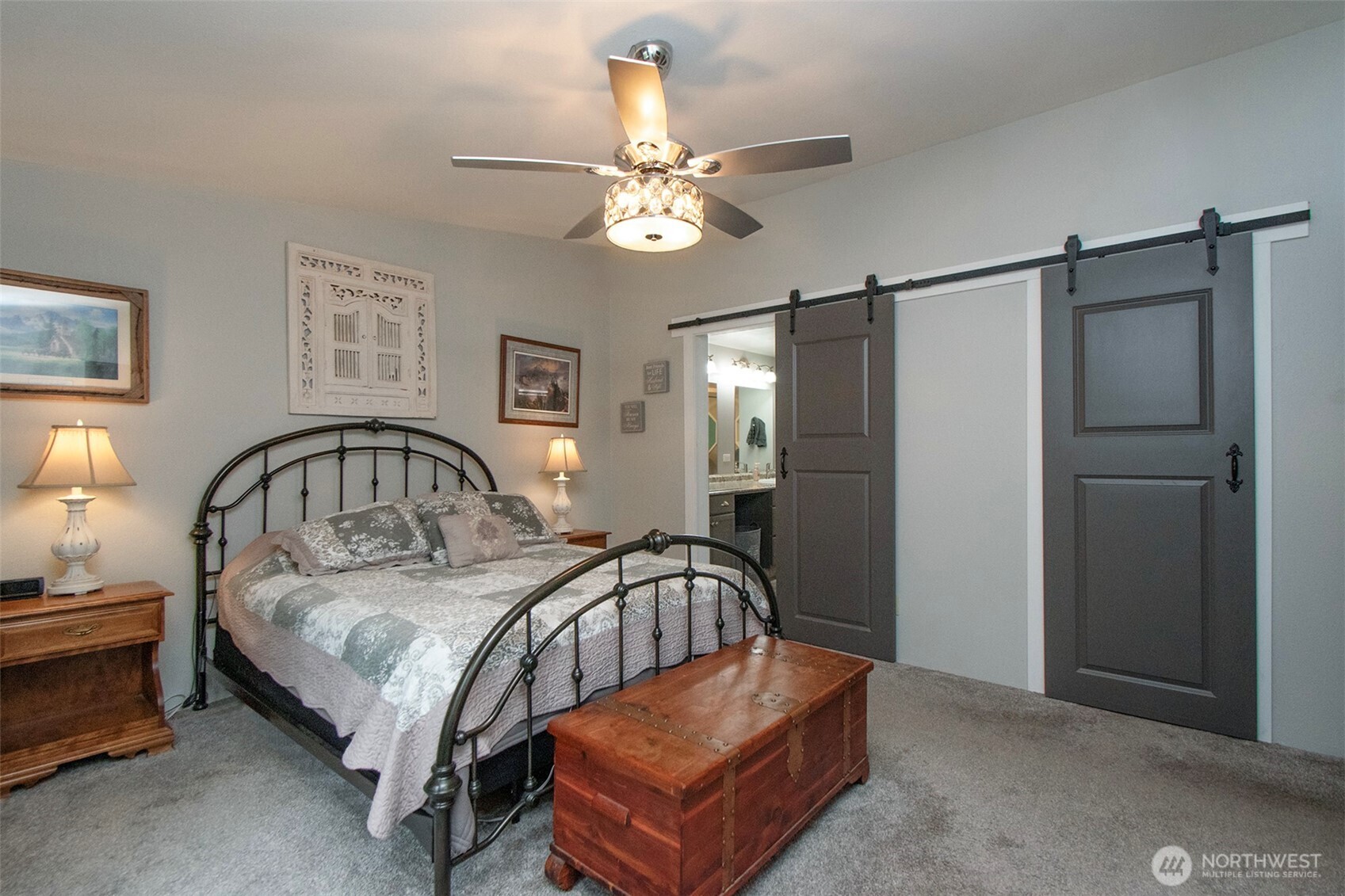 141 Lavender Ridge Lane Sequim, WA 98382 - Photo 20 of 40 a bedroom with a bed mirror and a chandelier