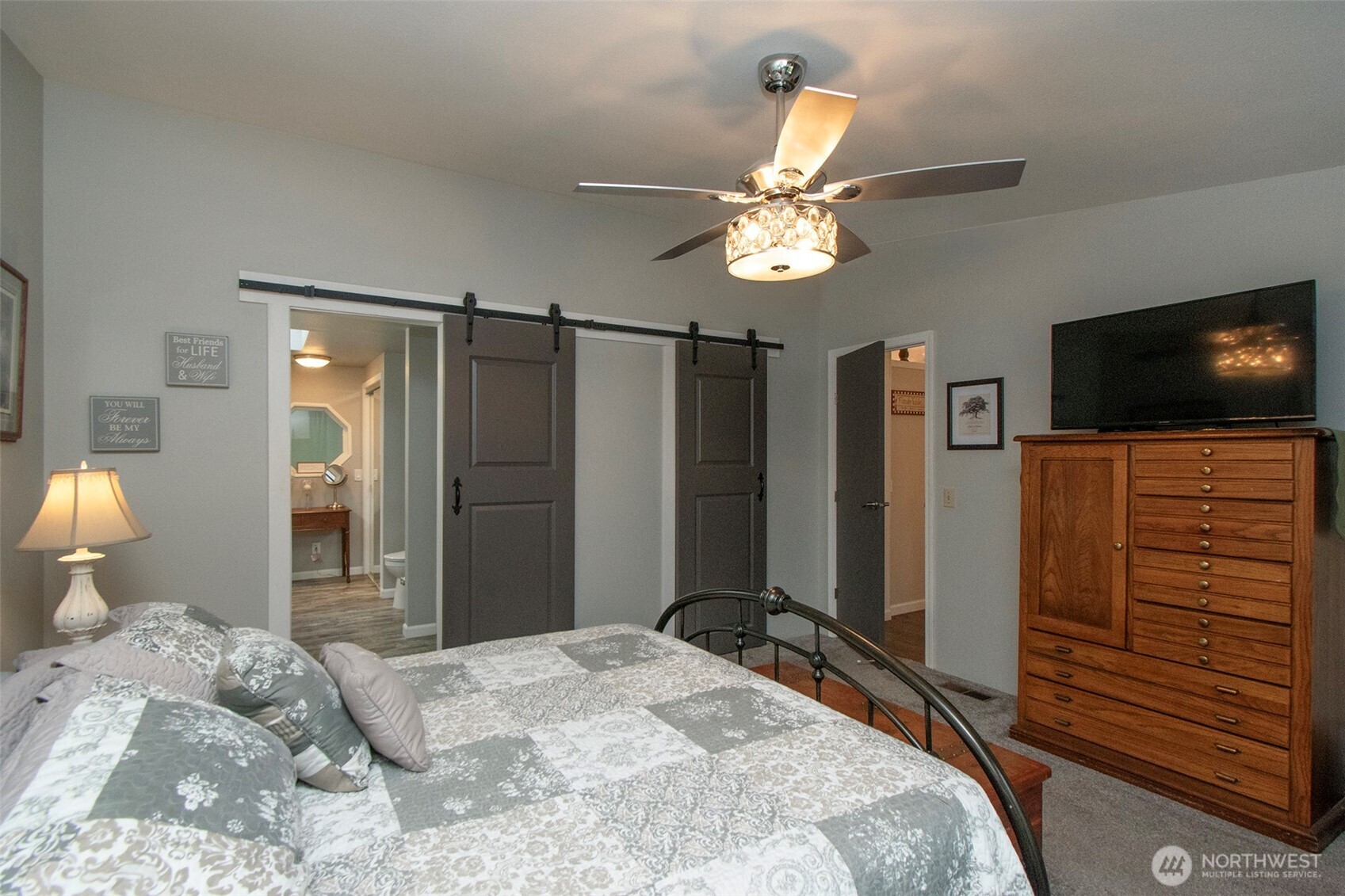 141 Lavender Ridge Lane Sequim, WA 98382 - Photo 21 of 40 a bedroom with a bed and a flat tv screen on dresser