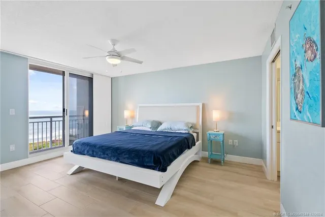 a spacious bedroom with a bed and a painting on the wall