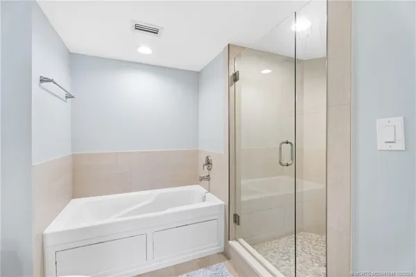 a bathroom with a bathtub and a shower