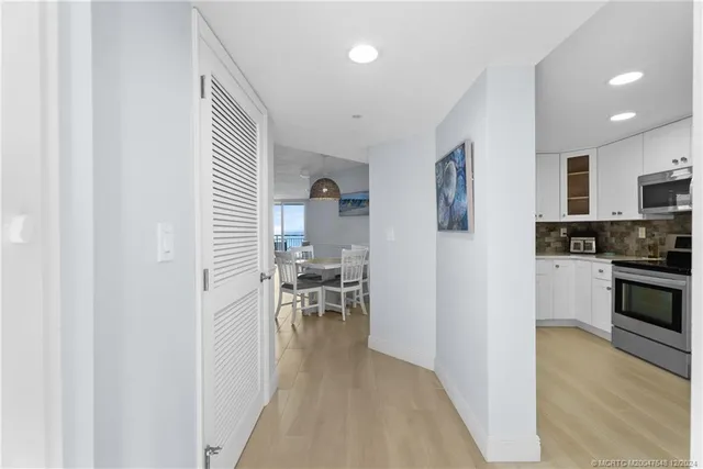 a view of a kitchen with kitchen island and stainless steel appliances