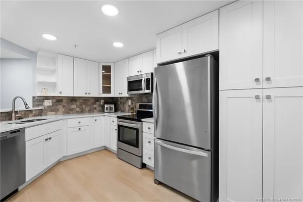 a white refrigerator freezer sitting inside of a kitchen