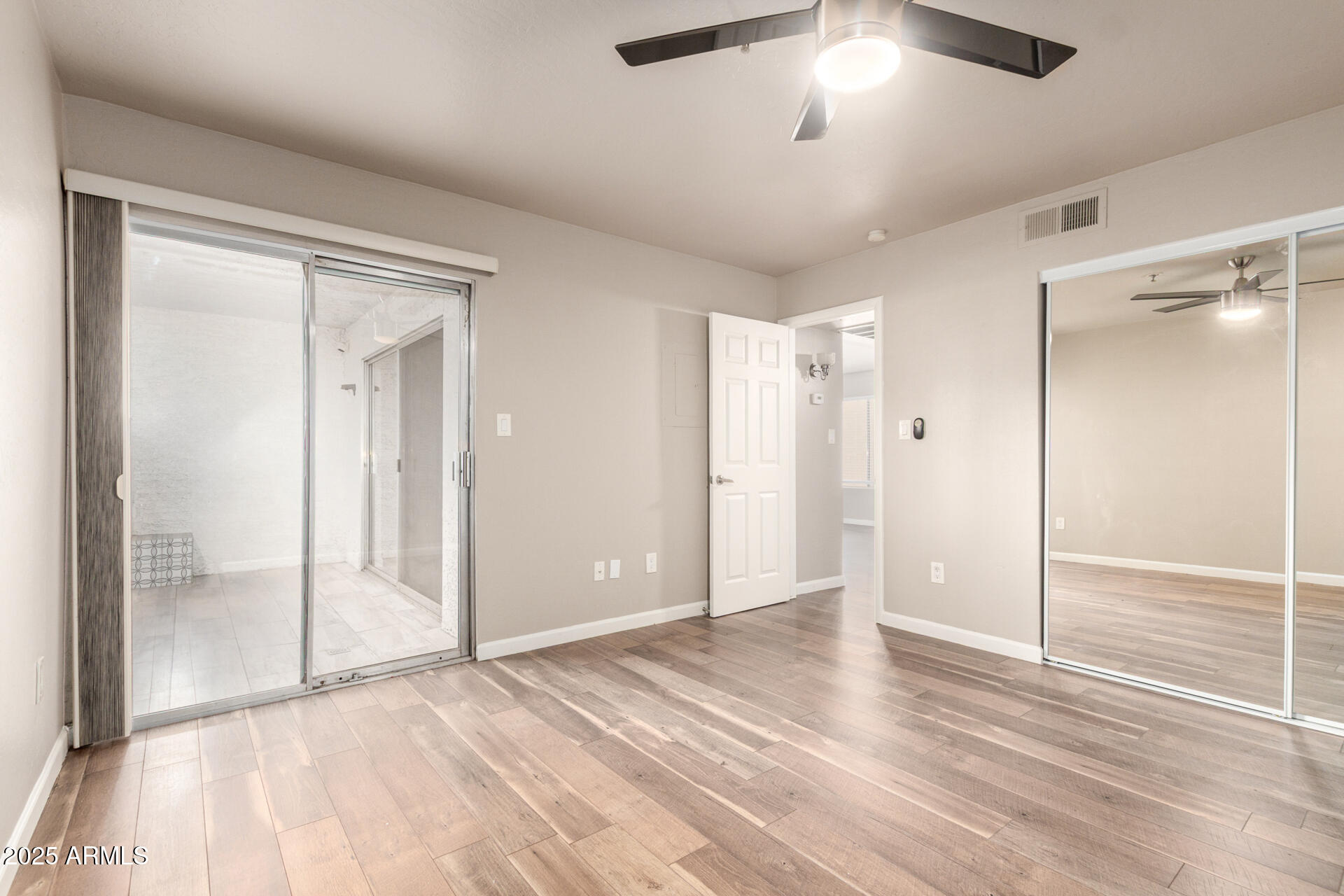 7494 East Earll Drive, Unit 107 Scottsdale, AZ 85251 - Photo 14 of 23 a view of an empty room and wooden floor