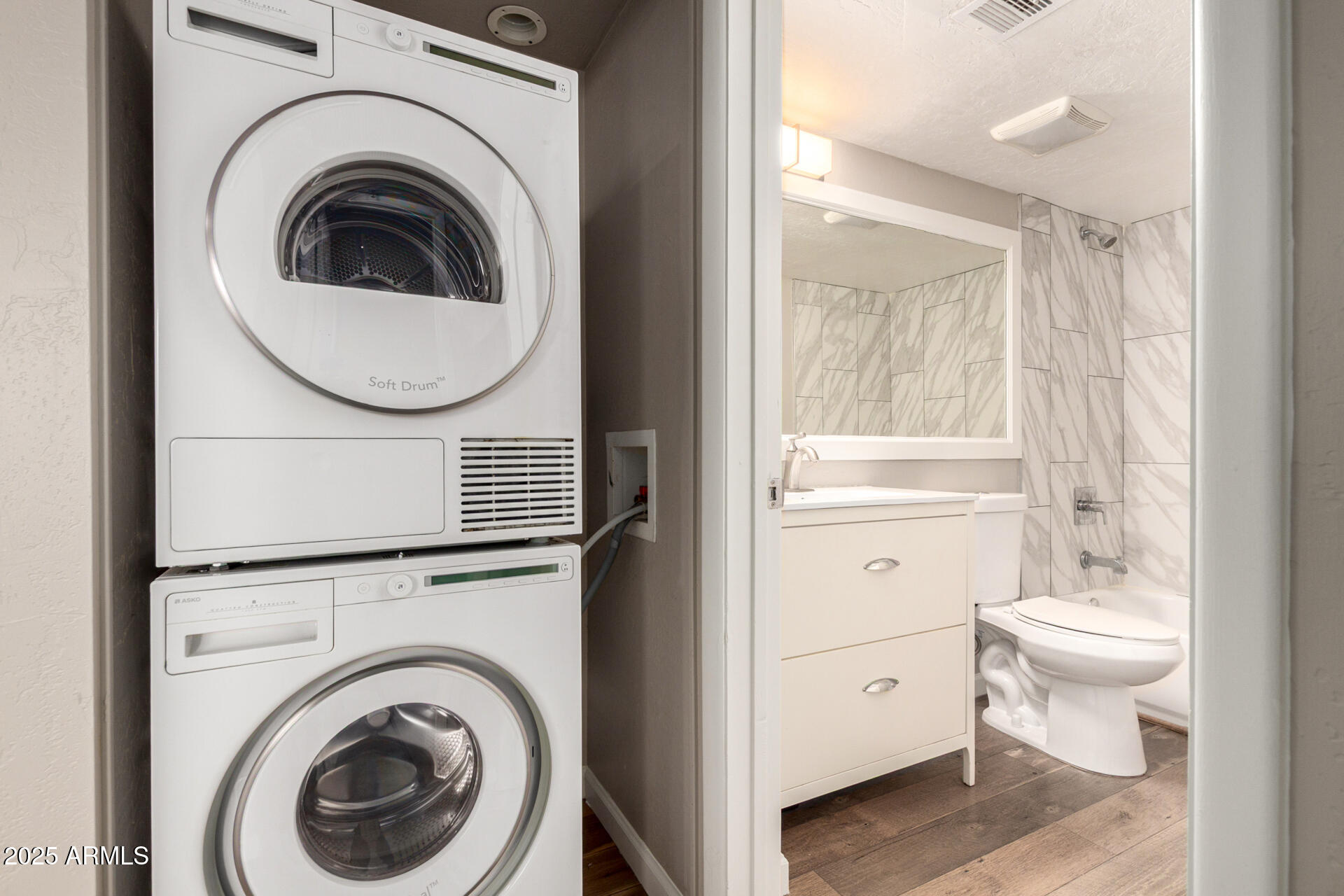 7494 East Earll Drive, Unit 107 Scottsdale, AZ 85251 - Photo 16 of 23 a bathroom with a toilet a sink and a mirror