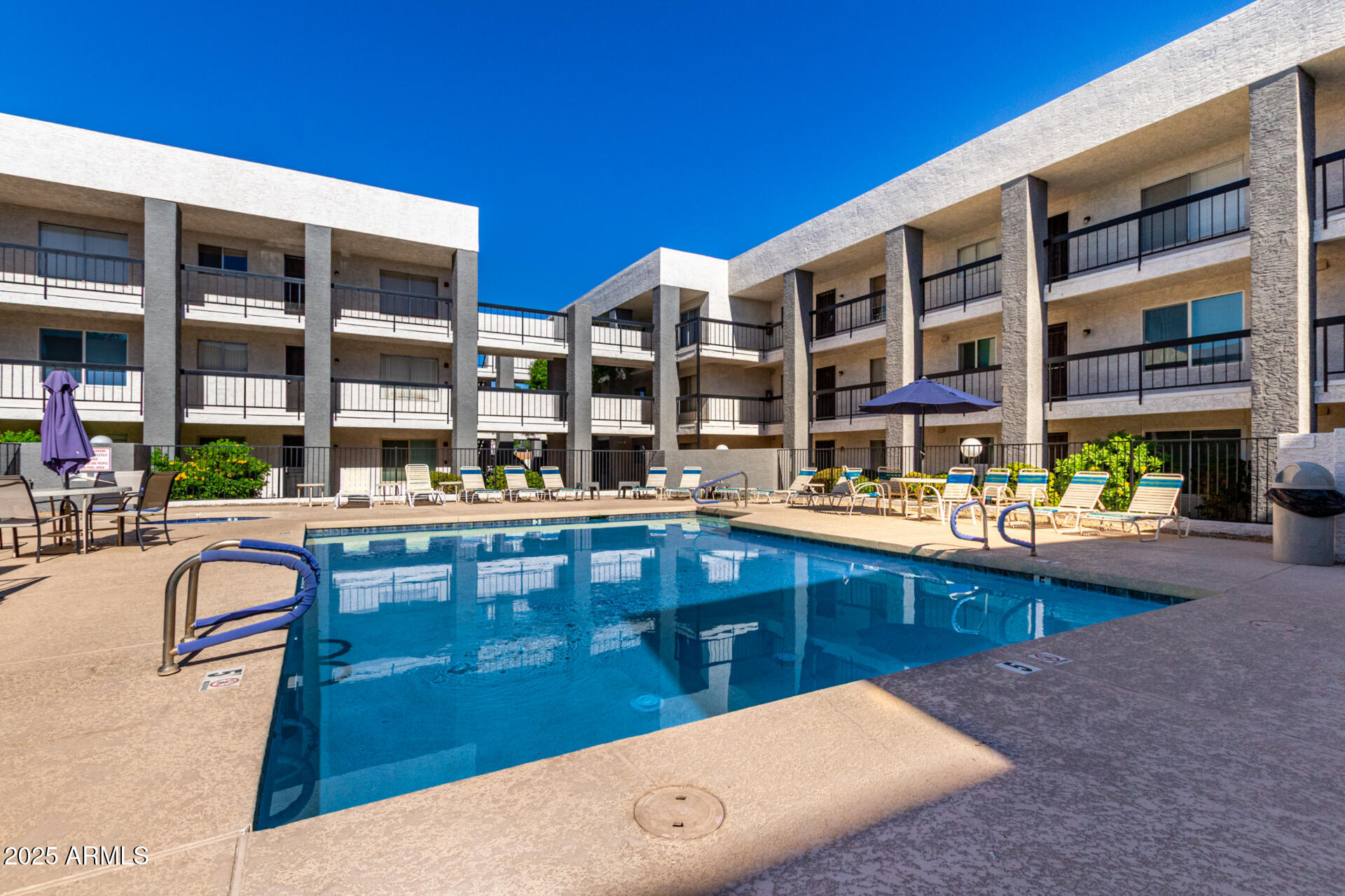 7494 East Earll Drive, Unit 107 Scottsdale, AZ 85251 - Photo 20 of 23 a swimming pool with outdoor seating and yard