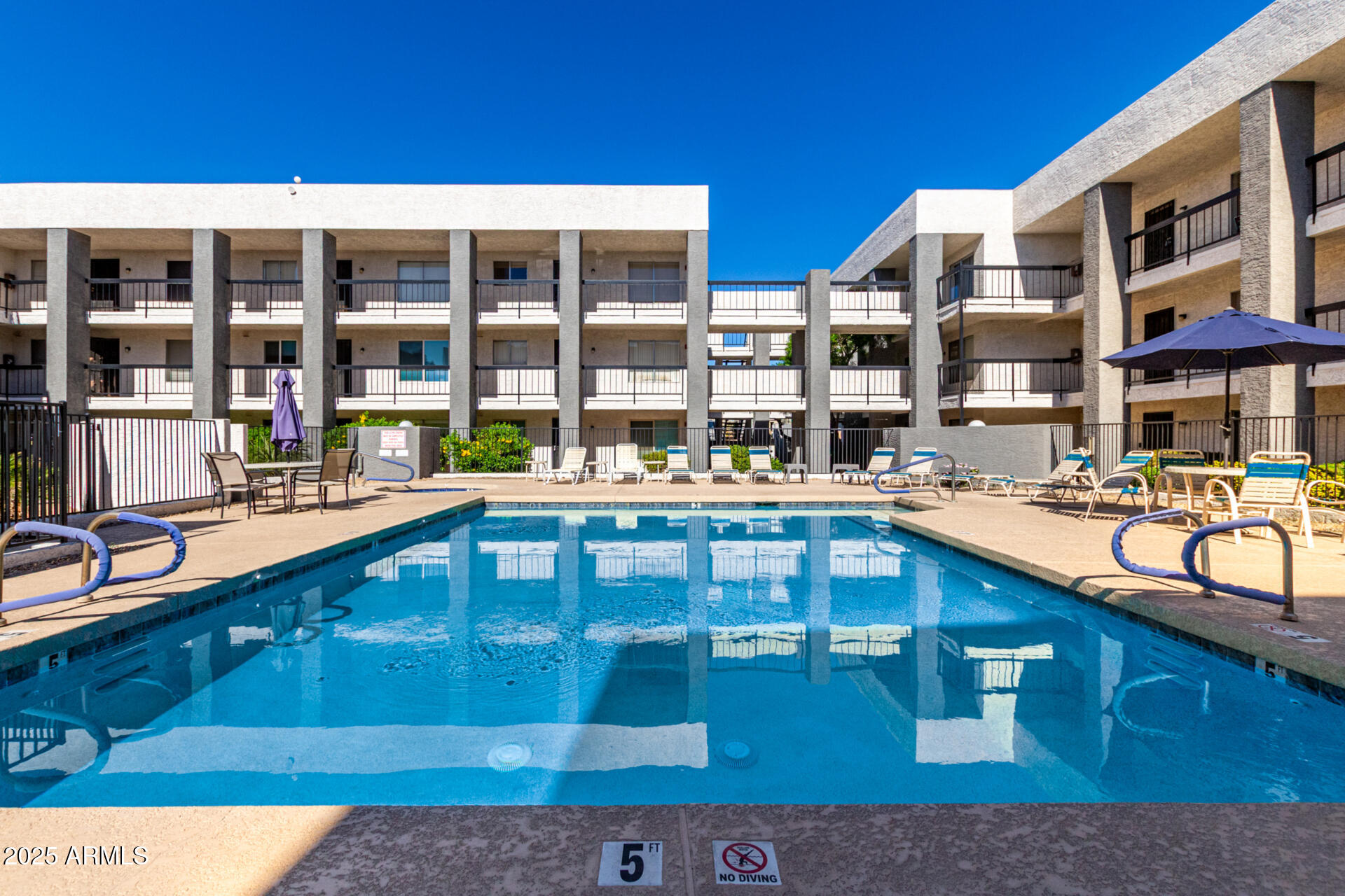 7494 East Earll Drive, Unit 107 Scottsdale, AZ 85251 - Photo 21 of 23 a large building with swimming pool in front of it