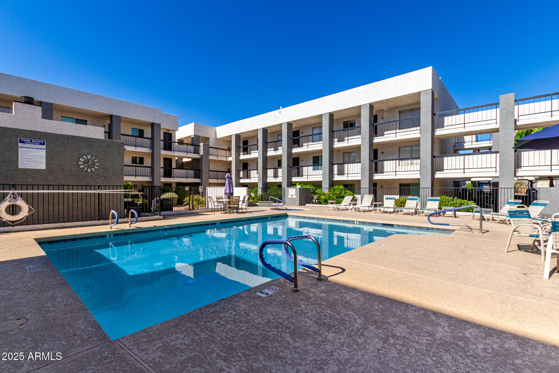 7494 East Earll Drive, Unit 107 Scottsdale, AZ 85251 - Photo 22 of 23 a swimming pool with outdoor seating and yard