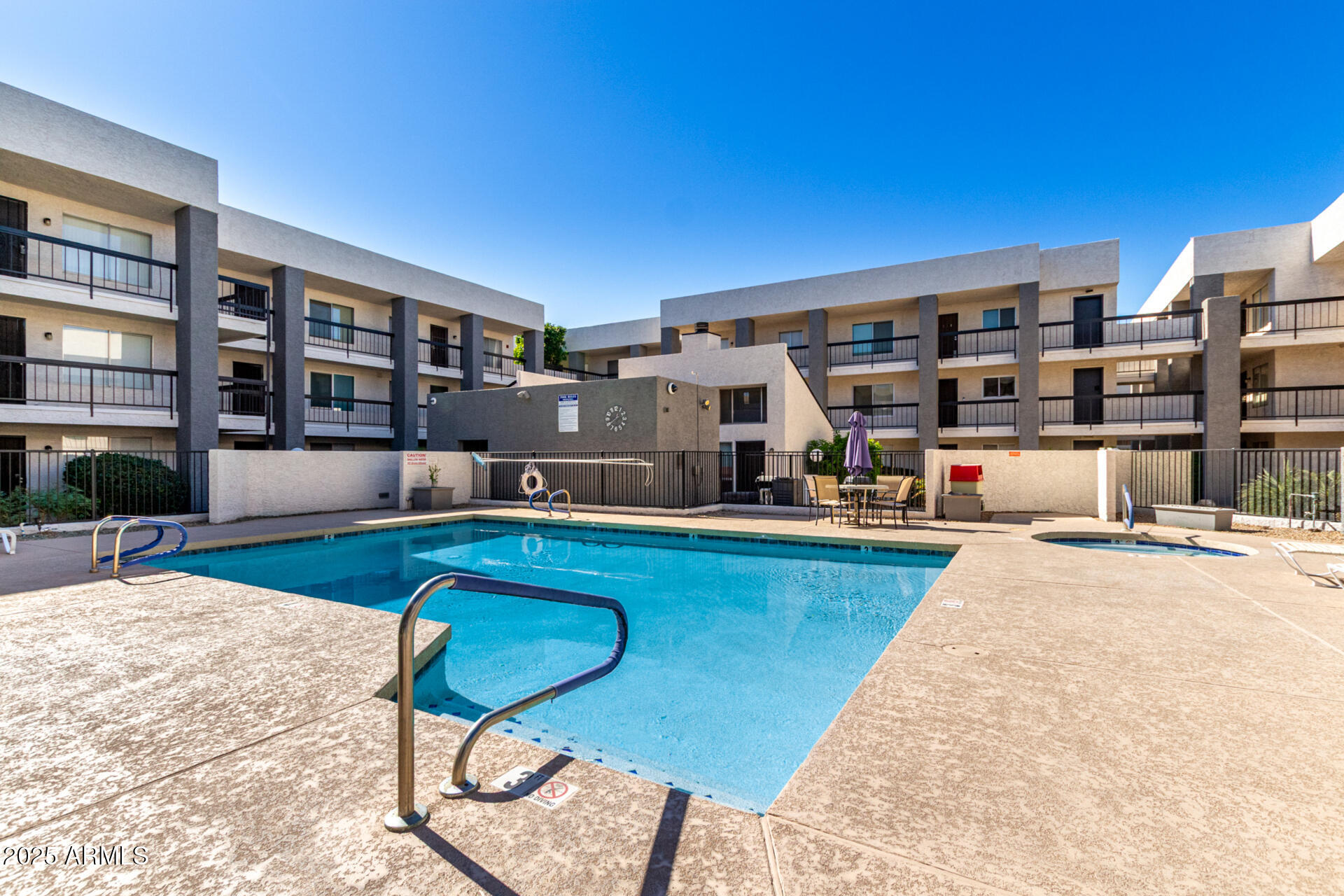 7494 East Earll Drive, Unit 107 Scottsdale, AZ 85251 - Photo 23 of 23 a swimming pool with outdoor seating and yard
