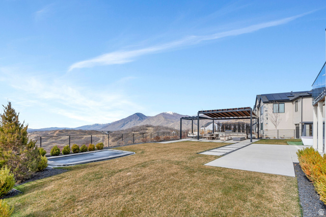 3918 South Mapleton Ests Drive Mapleton, UT 84664 - Photo 74 of 103 Fenced backyard featuring a patio area, a pergola, and a mountain view