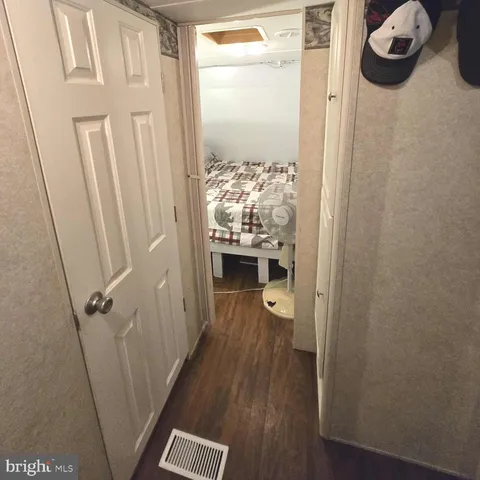 a view of a room with wooden floor