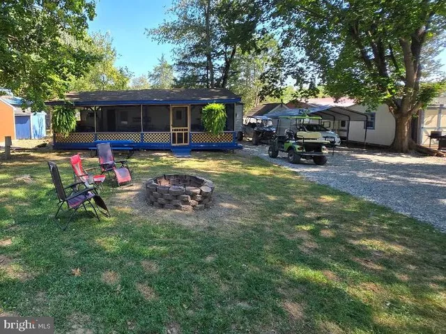 a view of a house with backyard porch and sitting area