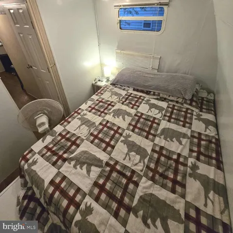 a bedroom with a bed and a mirror