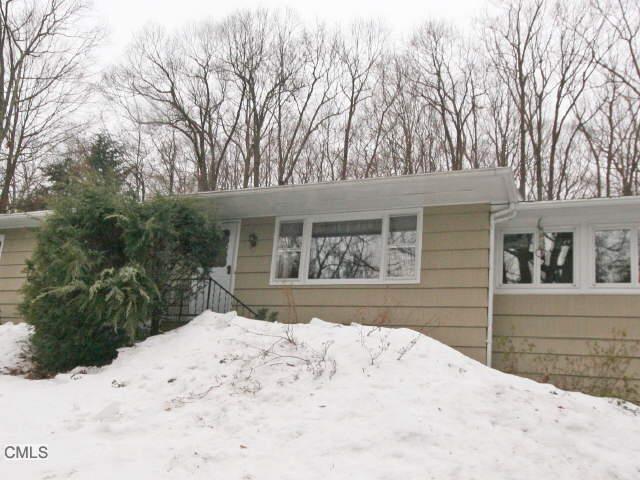 26 Weed Road Bethel, CT 06801 - Photo 1 of 1 a front view of a house with a yard covered in snow
